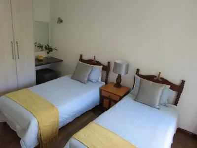 two beds sitting next to each other in a room at 10 Kommandeurs Ave, Stellenbosch in Stellenbosch