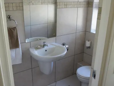 a bathroom with a sink and a toilet at 10 Kommandeurs Ave, Stellenbosch in Stellenbosch