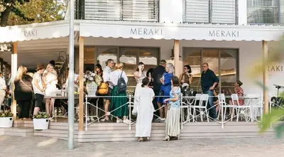 a group of people standing outside of a restaurant at Concord Apartment in Stellenbosch