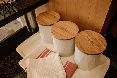 three cups sitting on top of a counter at Concord Apartment in Stellenbosch