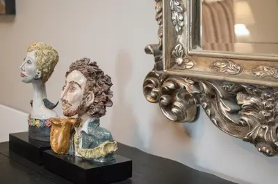 a statue of a bust next to a mirror at A' Queenslin Guesthouse in Paarl