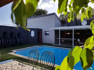 a swimming pool in the backyard of a house at A' Queenslin Guesthouse in Paarl