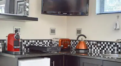 a kitchen with a counter top with a microwave at 1AA Wilhelmina Luxury Suites in Franschhoek