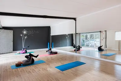 a group of people doing yoga in a room at Trail's End in Elgin