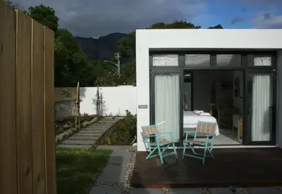 a house with a table and chairs on a patio at No. 9 Keurboom in Cape Town