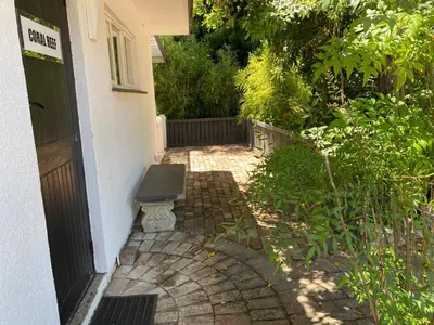 a door to a house with a bench next to it at Willows Curve in Somerset West
