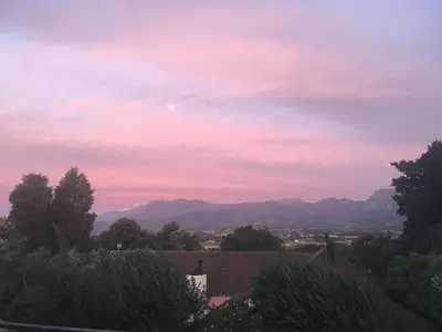 a view of a pink sky with mountains in the background at Paarl Mountain Lodge in Paarl