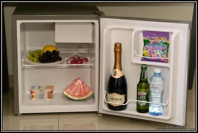 an open refrigerator with a bottle of wine and fruit at Paarl Mountain Lodge in Paarl