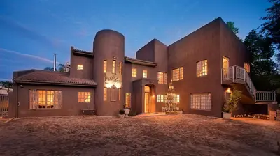 a large brick house with its lights on at Baruch Guesthouse on Lovell in Stellenbosch