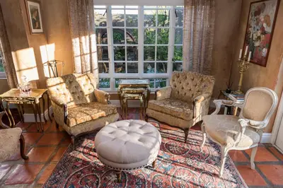 a living room with furniture and a large window at Baruch Guesthouse on Lovell in Stellenbosch