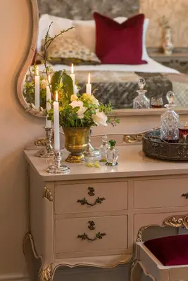 a bedroom with a bed with candles on a dresser at Baruch Guesthouse on Lovell in Stellenbosch