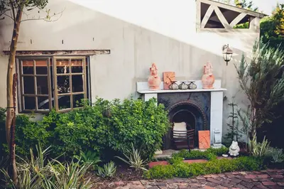 a house with a fireplace in a yard at Station House Simondium in Simondium