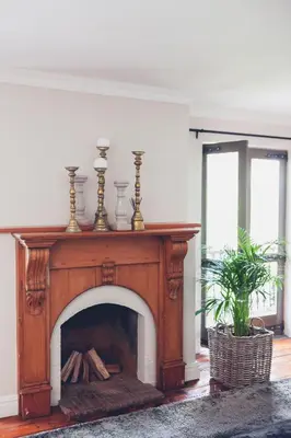 a fireplace with three vases on top of it at Station House Simondium in Simondium