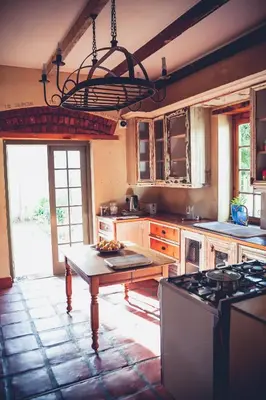 a large kitchen with a table and a chandelier at Station House Simondium in Simondium