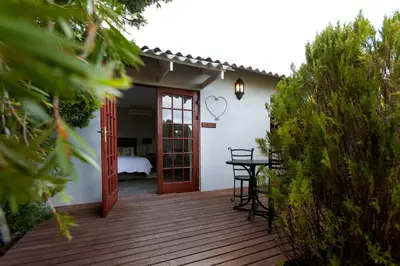 a wooden deck with a door leading to a bedroom at Summerhill Guest Farm in Worcester