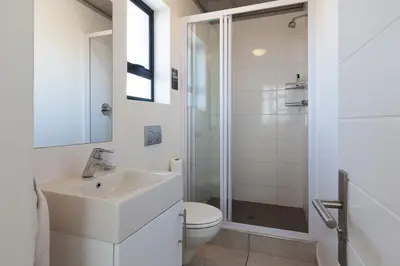 a white bathroom with a sink and a toilet at Key West 417 by CTHA in Cape Town