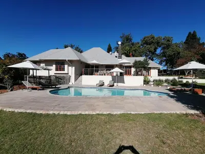 a house with a swimming pool in the yard at Lauradale Accommodation in Stellenbosch