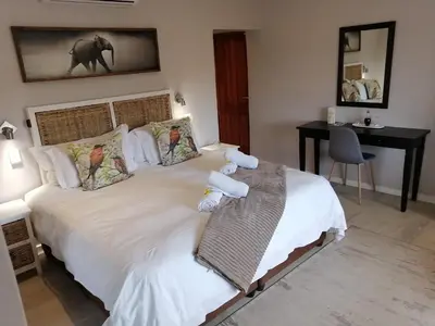 a bedroom with a bed with two stuffed animals on it at Lauradale Accommodation in Stellenbosch
