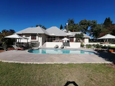 a house with a swimming pool in the yard at Lauradale Accommodation in Stellenbosch