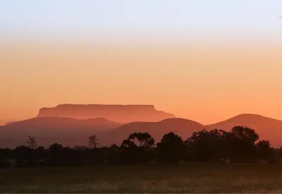 a sunset with the table mountain in the background at Maleki in Windmeul