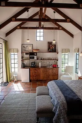 a large room with a bed and a kitchen at Maleki in Windmeul