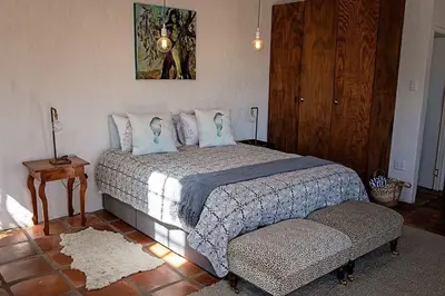 a bedroom with a large bed and a table at Maleki in Windmeul
