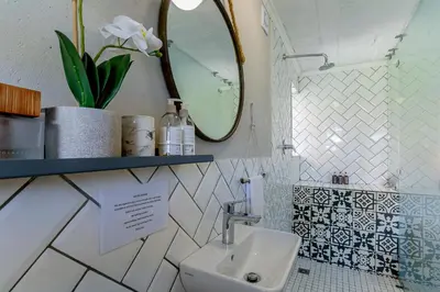 a bathroom with a sink and a mirror at Wildlife Retreat on a Wine-Farm in Stellenbosch