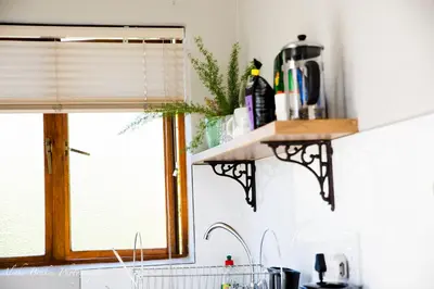 a kitchen counter with a sink and a window at Cobie Apartment in Stellenbosch