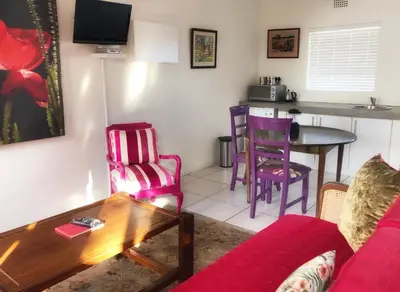 a living room with a couch and a table at BlackHorse Accommodation in Stellenbosch