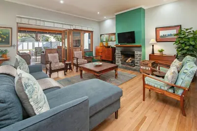 a living room with a couch and a fireplace at The Koppie - Accommodation in Hermanus