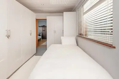 a bedroom with two beds and a window at The Koppie - Accommodation in Hermanus