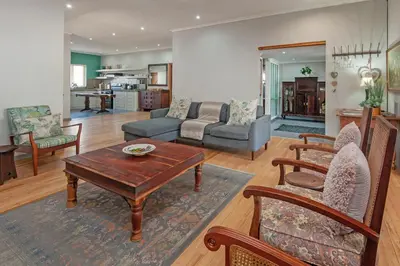 a living room with a table and chairs at The Koppie - Accommodation in Hermanus
