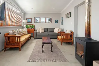a living room with a couch and a table at The Koppie - Accommodation in Hermanus