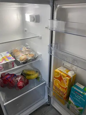an open refrigerator filled with food and vegetables at Azura Sleep Brackenfell in Brackenfell