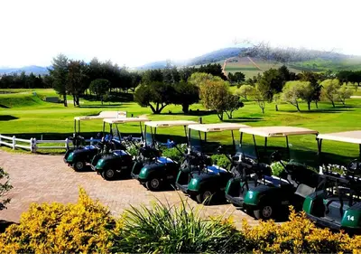a row of motorcycles parked next to a golf course at Azura Sleep Brackenfell in Brackenfell