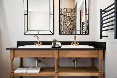 a bathroom with two sinks and two mirrors at d'Olyfboom Guest House B & B in Paarl