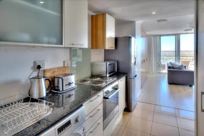 a kitchen with a counter top with a stove top oven at Horizon Bay 1404 by HMH in Bloubergstrand