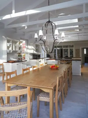 a dining room with a large wooden table and chairs at Vivere in Hermanus