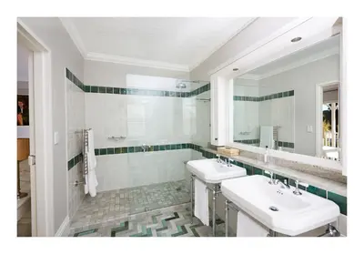 a bathroom with two sinks and a mirror at Vivere in Hermanus