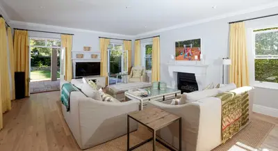 a living room with white furniture and a fireplace at Vivere in Hermanus