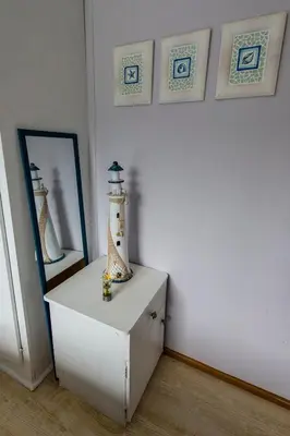 a room with a lighthouse on top of a dresser at Beach Cottage in Kleinmond