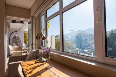 a living room with a table and a large window at 109 on Dorp in Stellenbosch