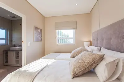 a large white bed in a bedroom with a window at 109 on Dorp in Stellenbosch