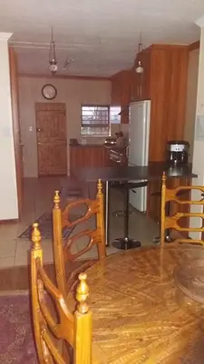 a kitchen with a wooden table and chairs at Overmeer in Worcester