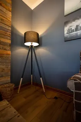 a lamp in a room with a blue wall at Modern Shabby Chic Apartment in Durbanville