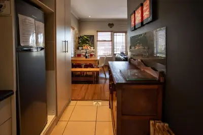 a kitchen with a sink and a counter top at Modern Shabby Chic Apartment in Durbanville