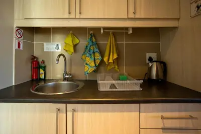a kitchen counter top with a sink and a counter top at Modern Shabby Chic Apartment in Durbanville