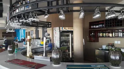 a bar in a restaurant with a counter and lights at Sunset 786 Holiday Accommodation Unit-207 in Strand