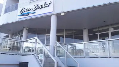 a sign on the side of a building with escalators at Sunset 786 Holiday Accommodation Unit-207 in Strand
