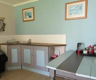 a kitchen with a table and a counter top at Da Capo in Bettyʼs Bay